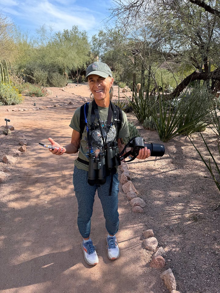 Emily and her mom holding cameras and binoculars while in the wild, both wearing Emily's brain bird t-shirt