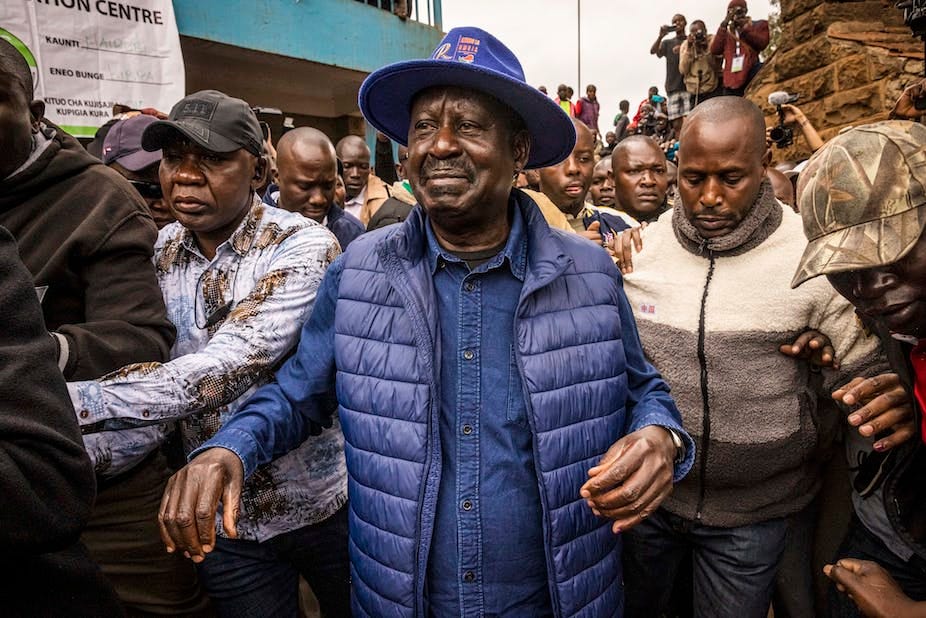 Raila Odinga leaves a polling station in Kibera Primary School after casting his vote Raila Odinga leaves a polling station in Kibera Primary School after casting his vote