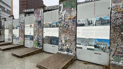 Two images of the busy intersection of Potsdamer Platz in November 2024. One image of the remaining slabs of the Berlin Wall at Potsdamer Platz, November 2024