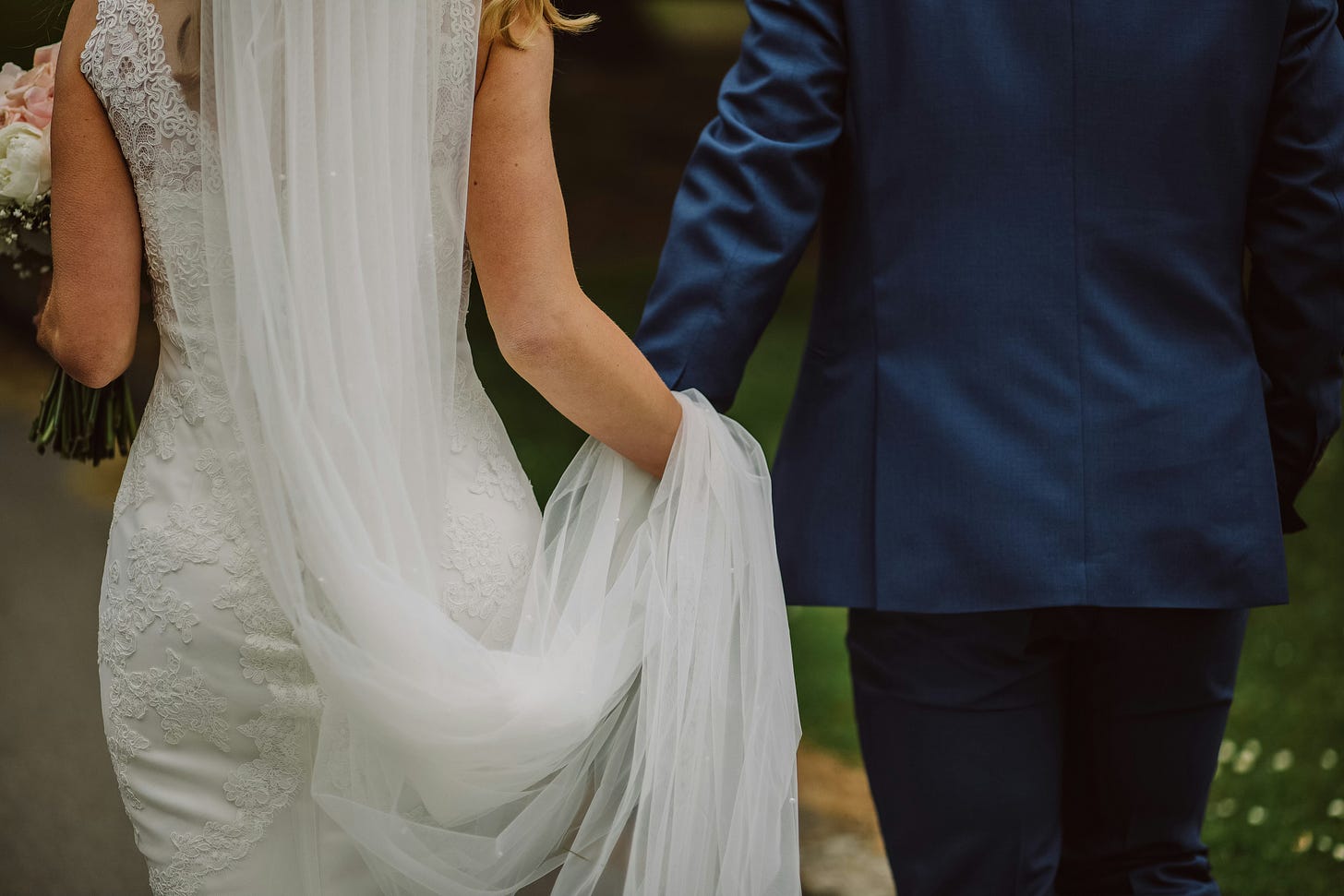 a bride and groom arm in arm