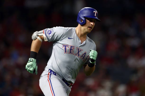 Nathaniel Lowe of the Texas Rangers runs to first base during the eighth inning against the Los Angeles Angels at Angel Stadium of Anaheim on...