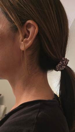 A person's ear with a ponytail

AI-generated content may be incorrect.