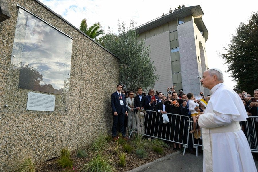 Pope Leo XIV prays before a memorial to abuse victims at Lourdes