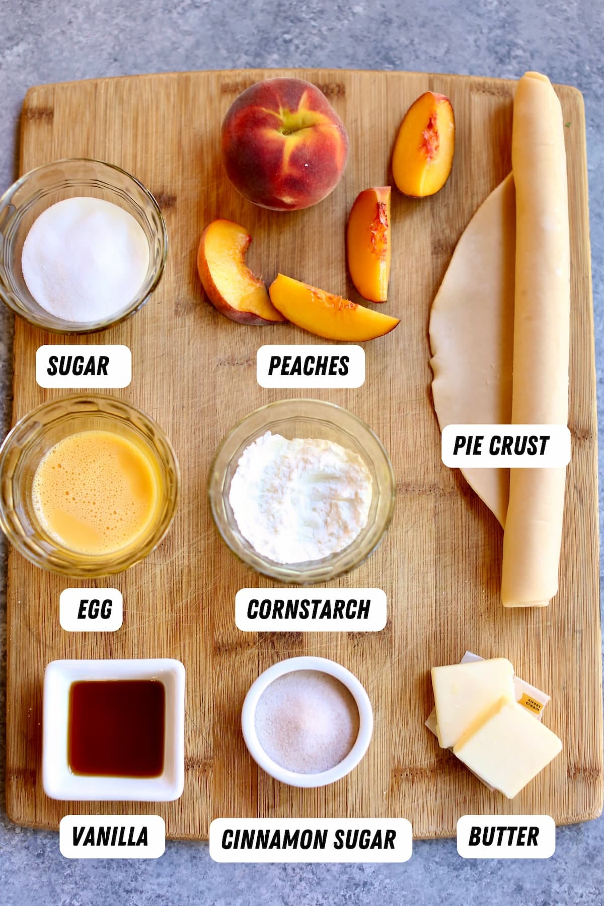 a cutting board of ingredients to make peach cobbler.