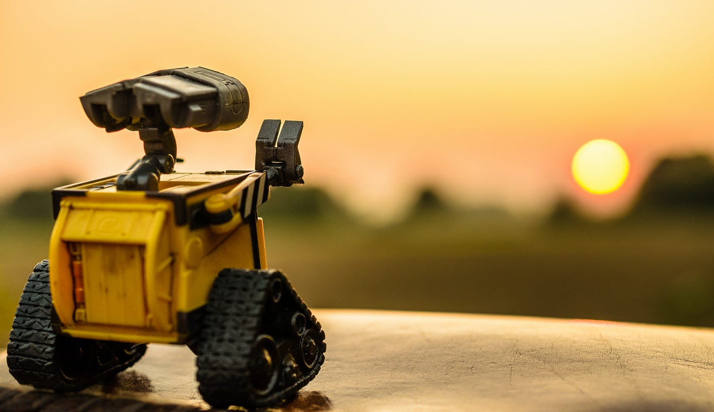 A toy version of WALL-E, from the Disney movie about this lonely curator of our ruined planet, waves at the sunset.