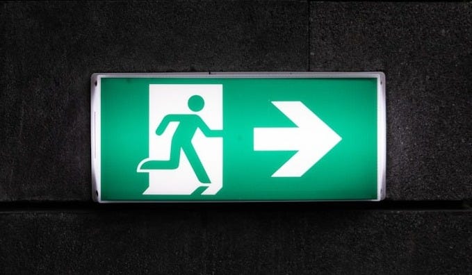 white and green Exit sign