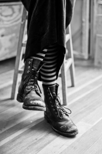 May be a black-and-white image of boots and wingtip shoes