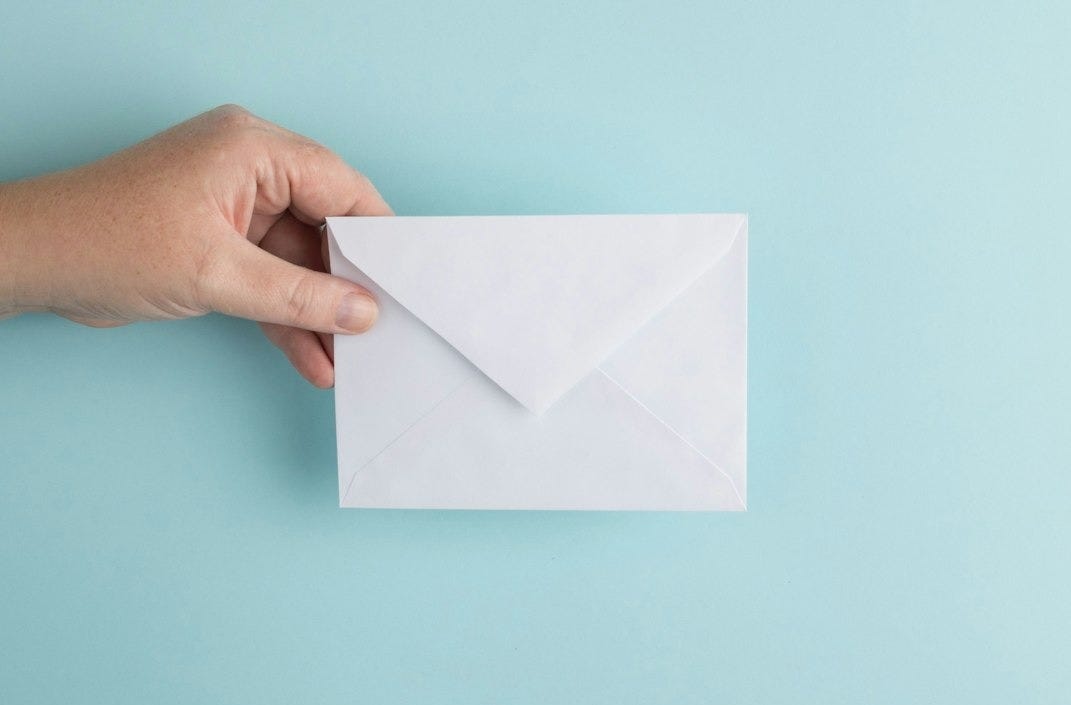 person showing white envelope