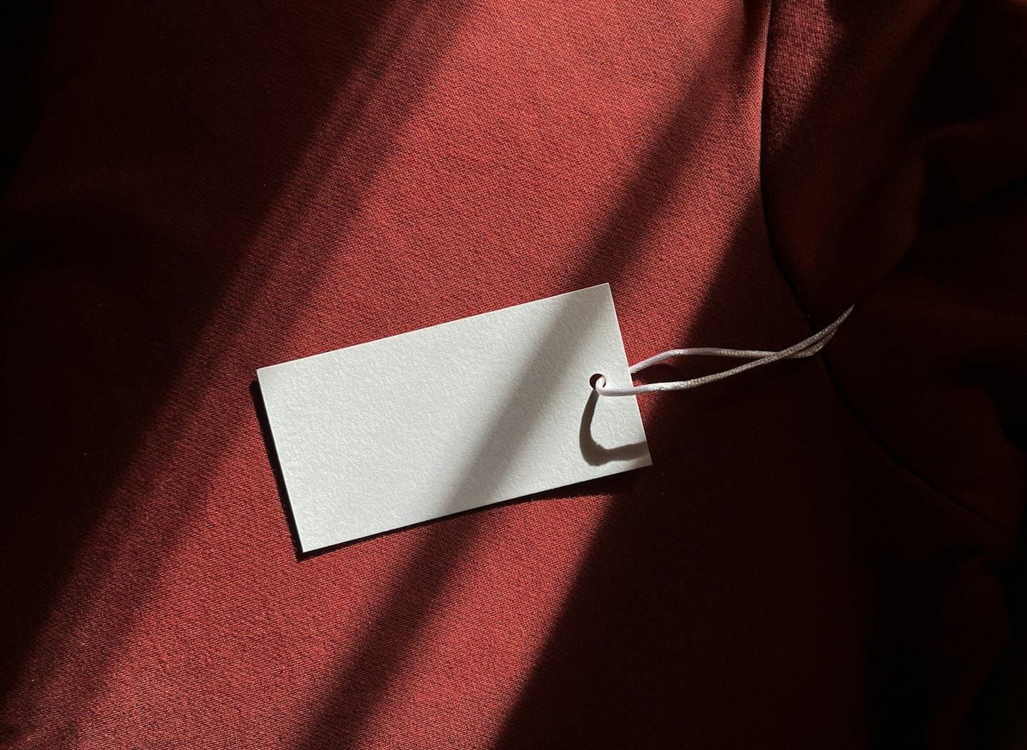 a red cloth with a white tag hanging from it