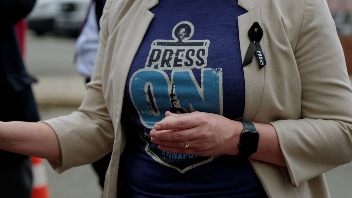 A shirt that says press on and a black ribbon A shirt that says press on and a black ribbon