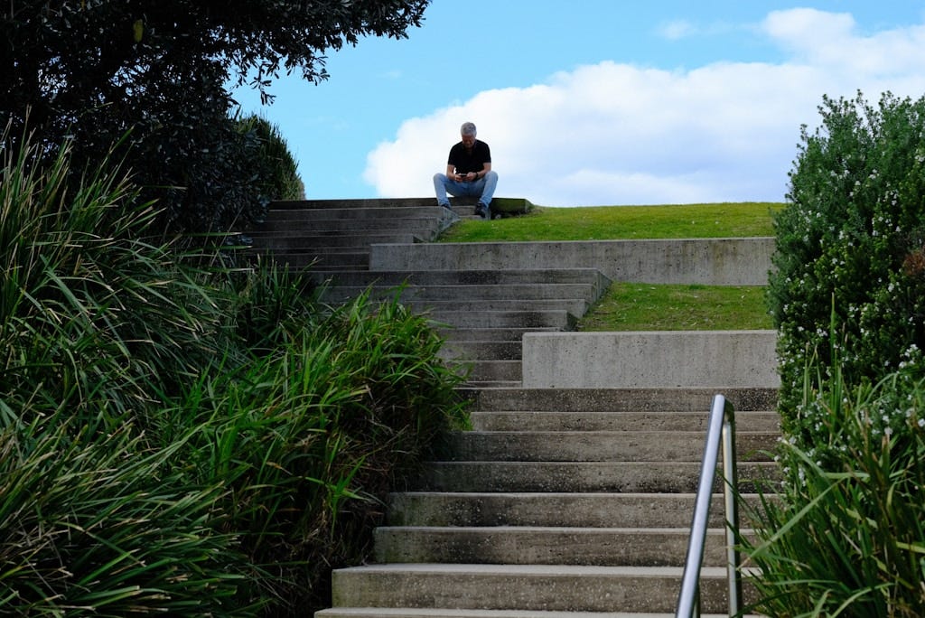 A person sitting on a set of stairs