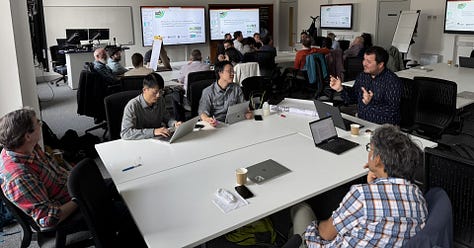 Five photographs of workshop attendees around tables in discussion, and a collage of speakers in front of presentations