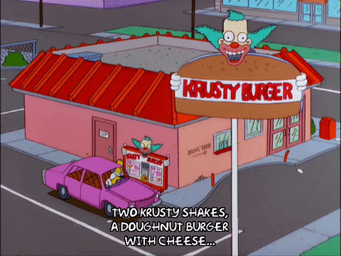 Animated GIF from The Simpsons zooming into Homer in a pink car placing an order at the Krusty Burger drive-thru