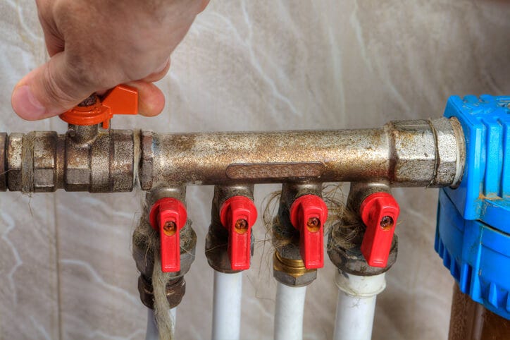 hand turning off water shut off valve on a pipe hand turning off water shut off valve on a pipe