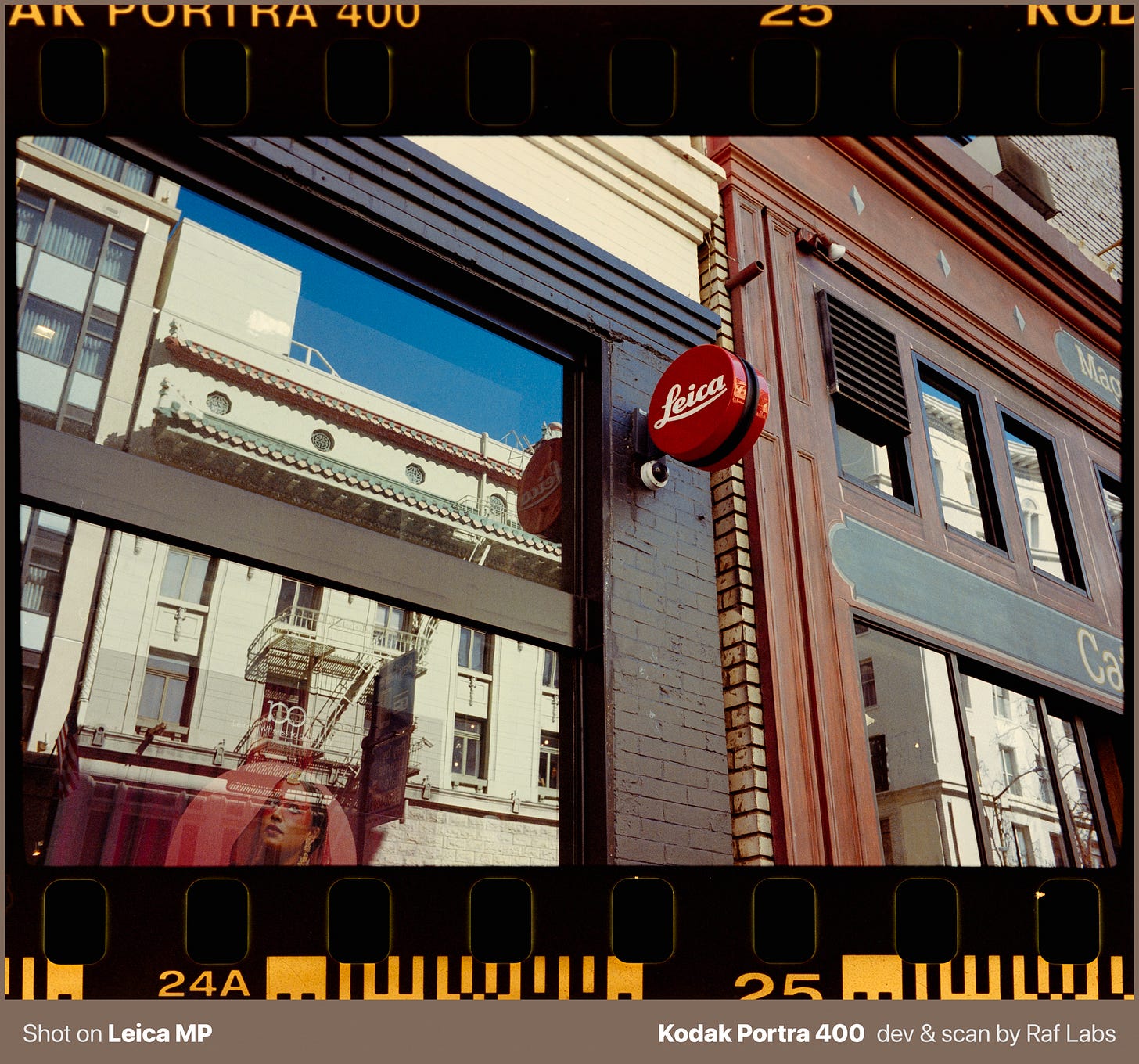 Leica camera store sign and window reflections showing San Francisco architecture, shot on 35mm film