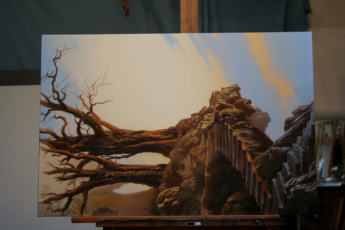 Work in progress photo of RISING with the panel turned on its side. Some of the sky has been rendered in blue. The trees are skeletal but more defined in texture. Everything is in earthy tones with the path of stairs winding down into the foreground.