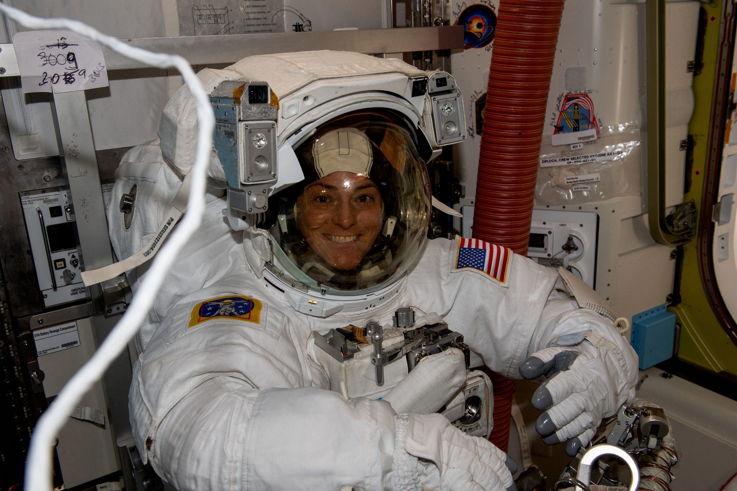 a woman in a spacesuit, preparing for a spacewalk