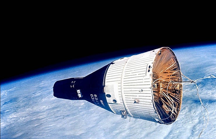 Space capsule orbiting Earth with black and white exterior, floating wires. Blue Earth and dark space in background. Space capsule orbiting Earth with black and white exterior, floating wires. Blue Earth and dark space in background.