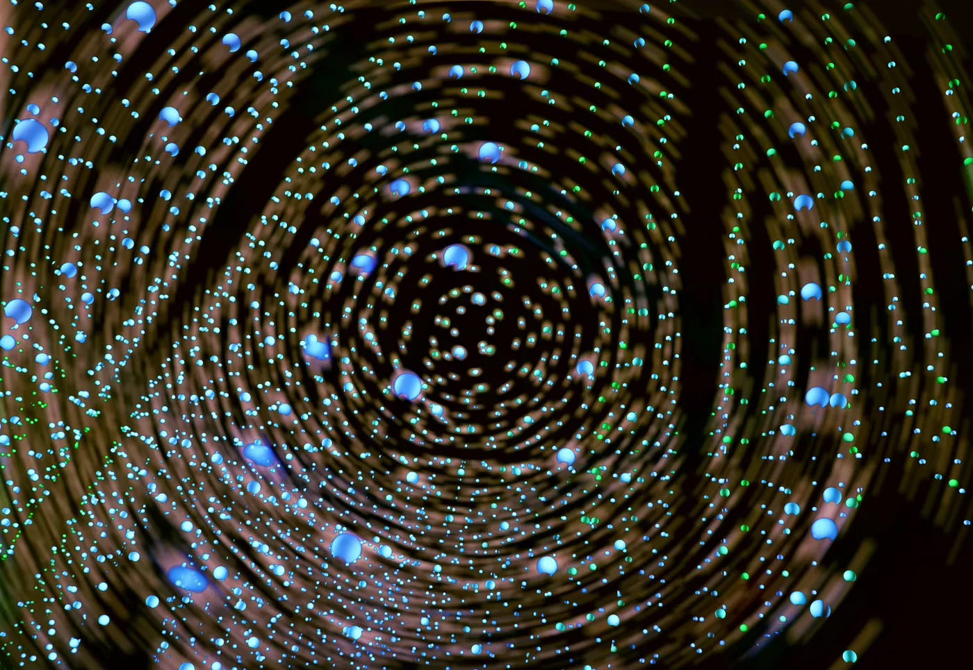 A photo of strands with glowing balls and lot of motion blur.