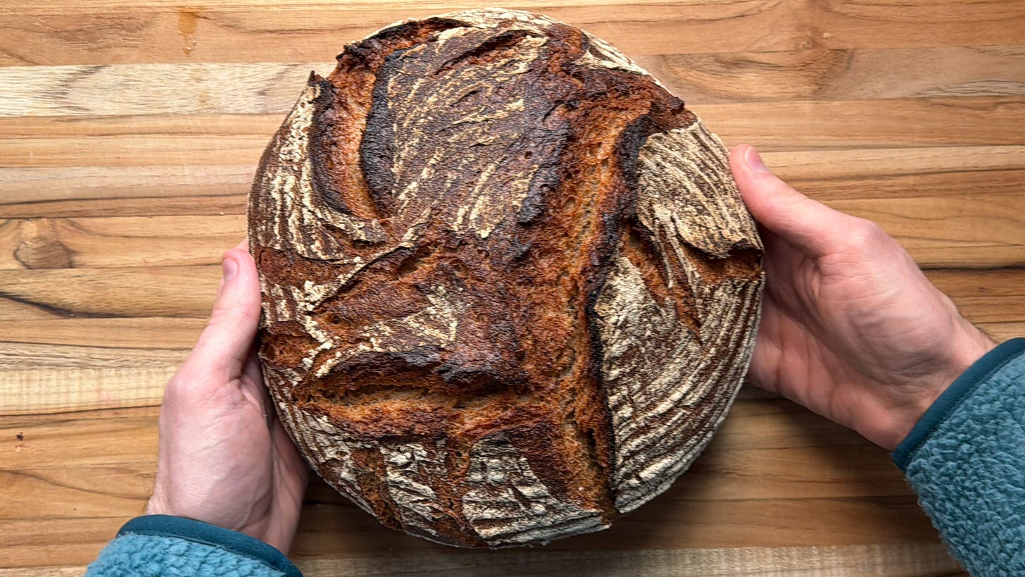 A craked, darkly-baked round loaf of bread. A craked, darkly-baked round loaf of bread.