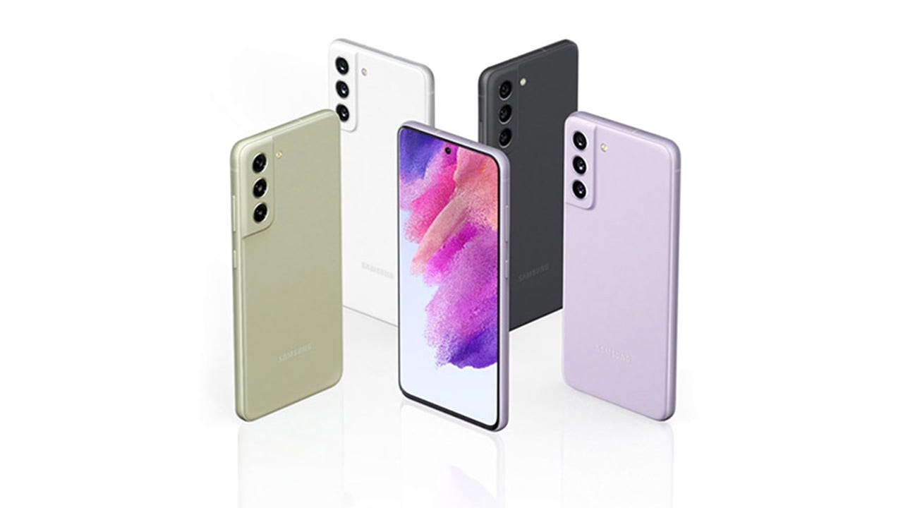 Five Galaxy S21 FEs arranged in a trapezoidal pattern, each standing on end