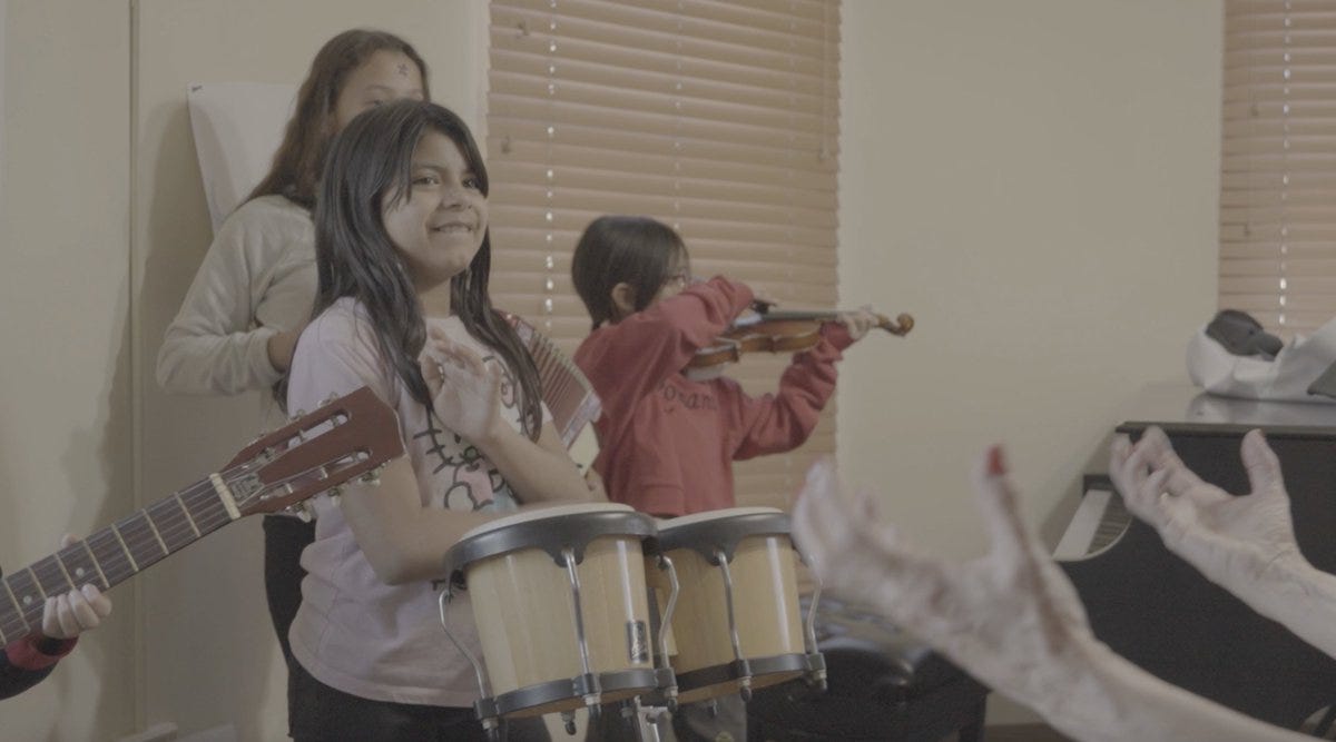 A group of children playing instruments

AI-generated content may be incorrect.