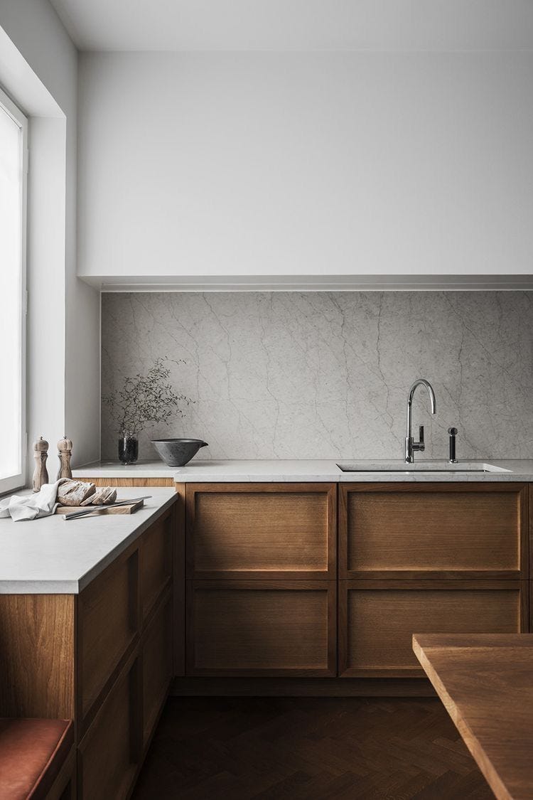 beautiful kitchen with crisp white walls and oak cabinets.