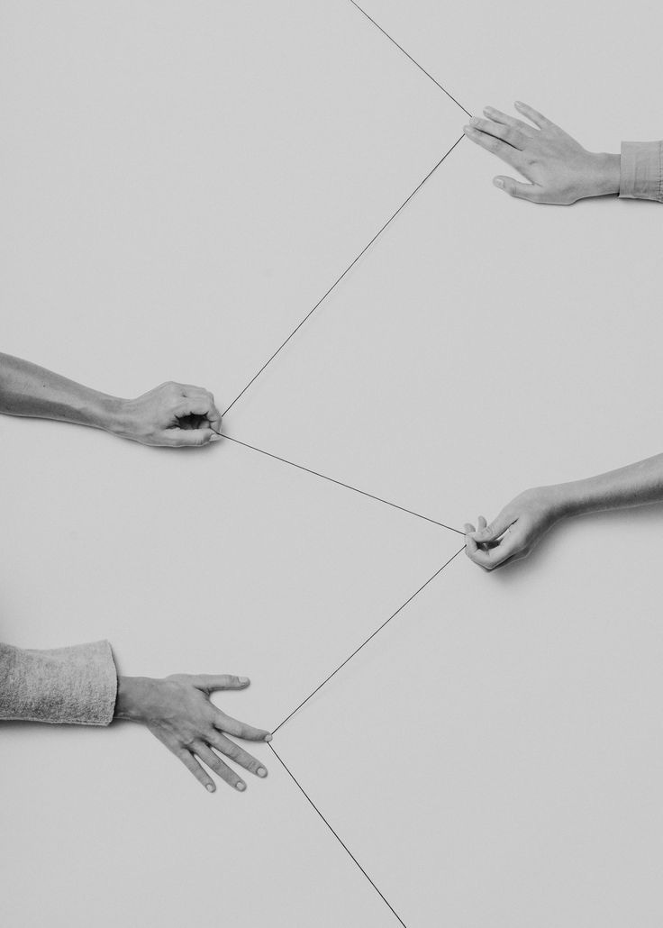 This may contain: four hands reaching for each other on a white surface with lines in the middle and one hand holding something This may contain: four hands reaching for each other on a white surface with lines in the middle and one hand holding something