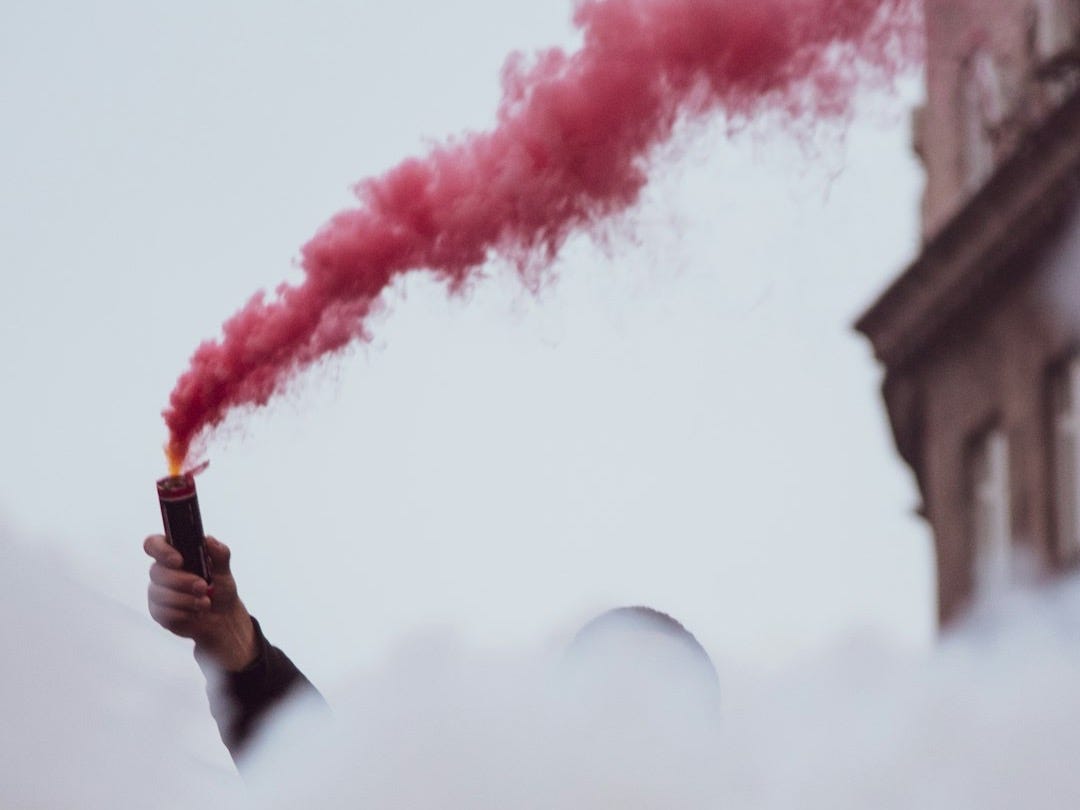 a hand holding a burning match