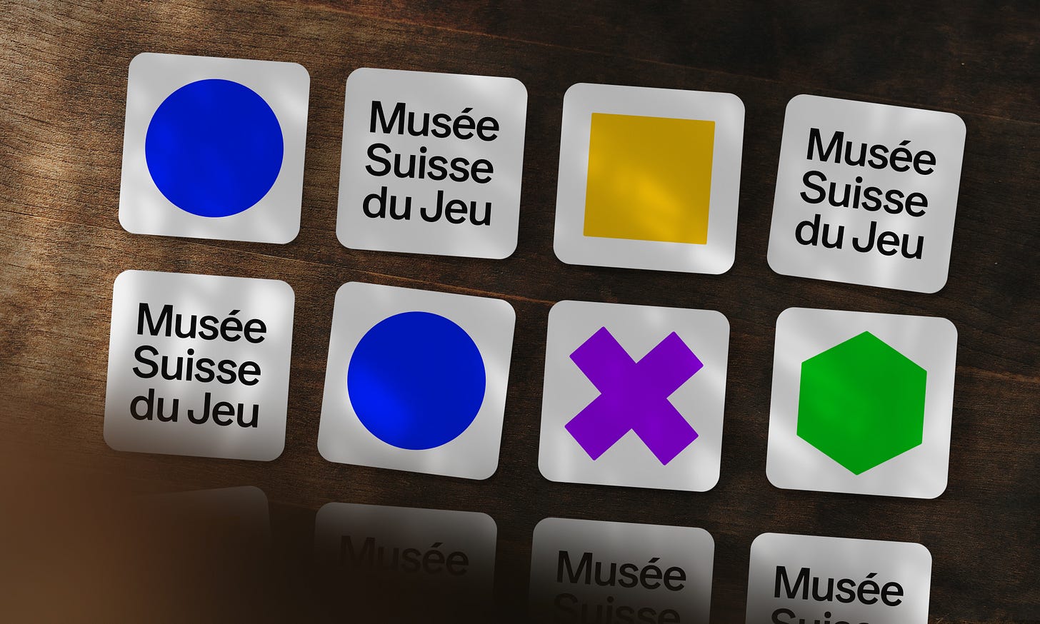 Various cards for Musée Suisse du Jeu featuring colourful shapes (blue circles, yellow square, purple "X", green hexagon) and the museum's name.