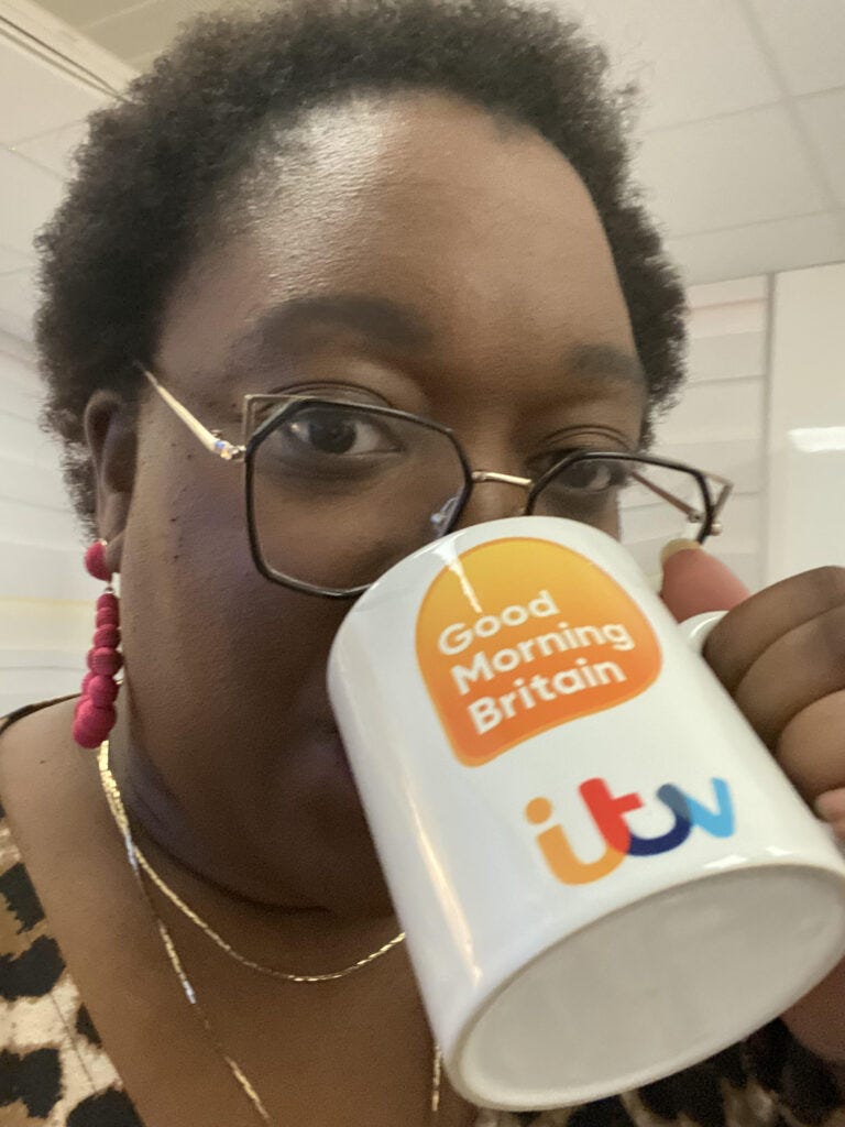 Tinuke drinking from an ITV mug awaiting her GMB slot 