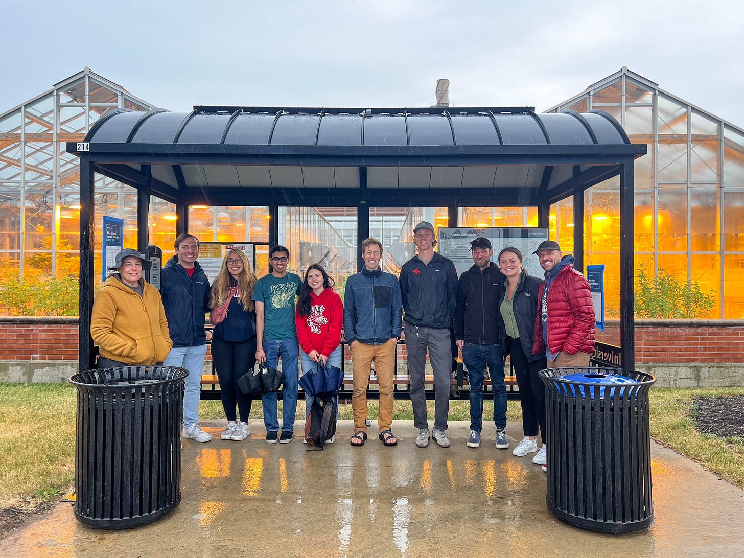 Project partners gather beneath a newly completed solar bus shelter by the Walnut Street Greenhouse. Project partners gather beneath a newly completed solar bus shelter by the Walnut Street Greenhouse.