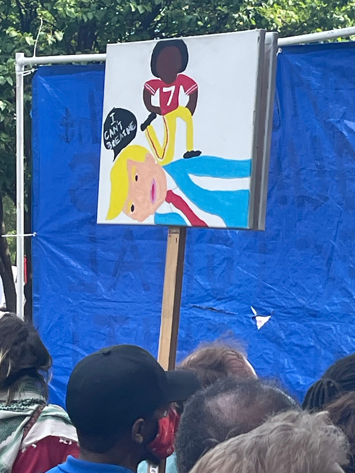 march picture; a sign with a Black person stepping on Trump; trump is saying "I can't breathe"