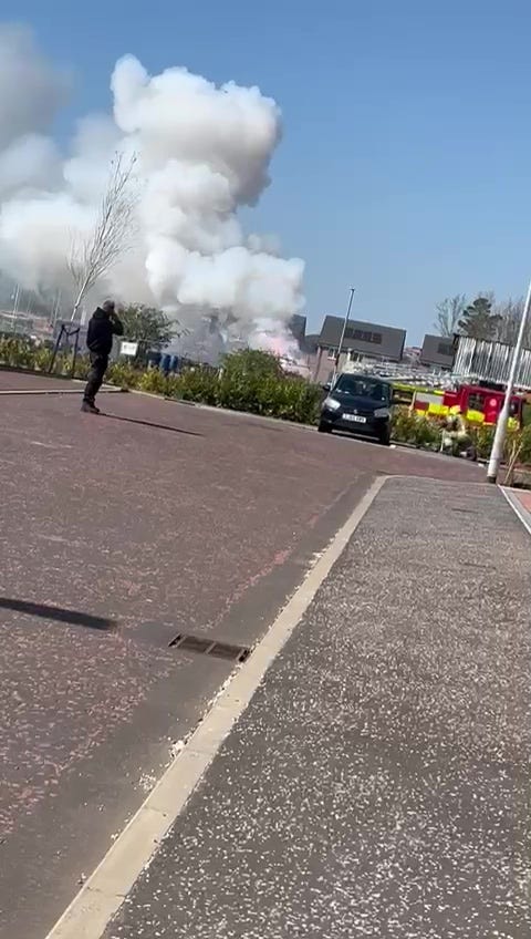 Large plume of smoke rising from a battery factory explosion.