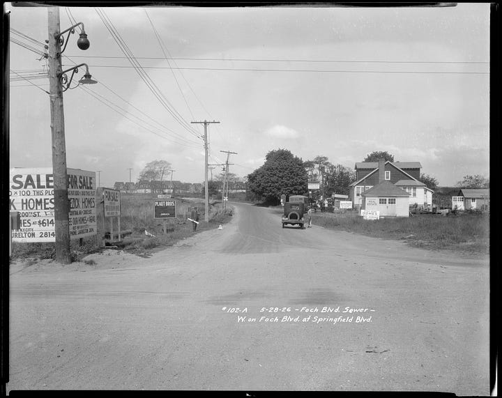 Images show Springfield, Queens, in the 1920s. Three images show tree-lined roads with autos and signs advertising new housing.