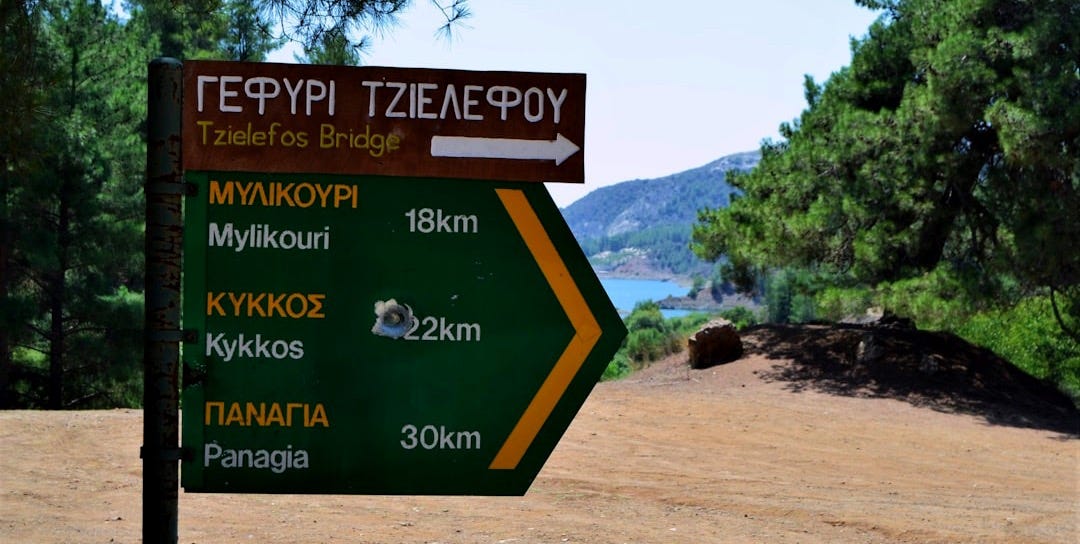 A sign that is on the side of a dirt road A sign that is on the side of a dirt road