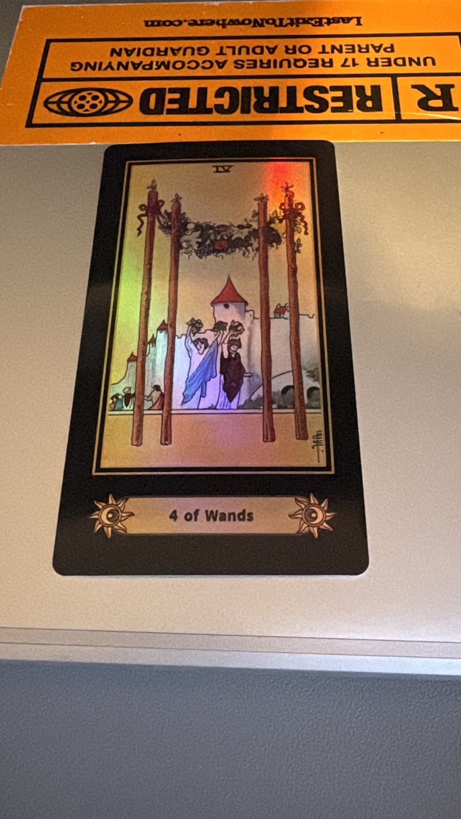 Four of Wands tarot card drawn by Harbinger screenwriter Simon Cluett during his Tarot DMs interview, shown on a surface beneath an orange Restricted label. Four of Wands tarot card drawn by Harbinger screenwriter Simon Cluett during his Tarot DMs interview, shown on a surface beneath an orange Restricted label.