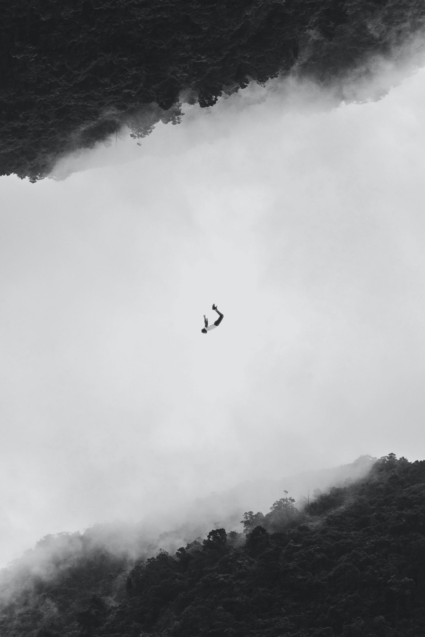 a single person falling from one world to another, suspended in the middle, isolated