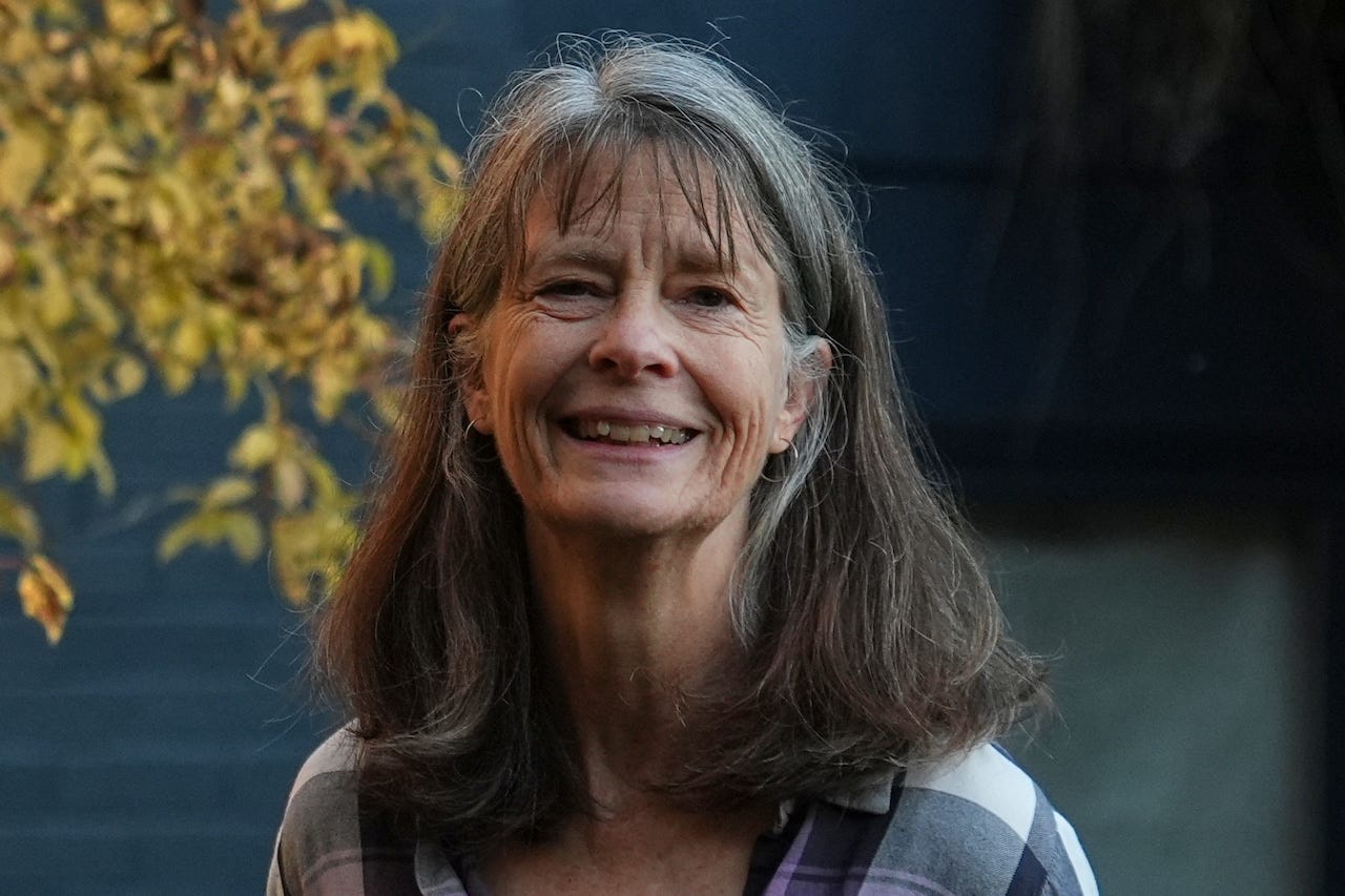 A photo shows molecular biologist Mary E. Brunkow posing for a portrait outside her home in Seattle after winning a Nobel Prize in medicine for part of her work on peripheral immune tolerance, in Seattle.