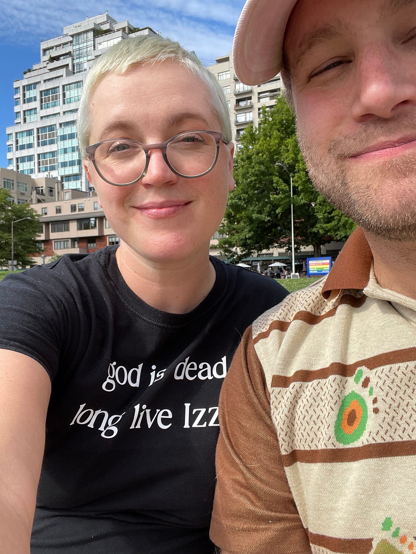 a picture of two swinty white people, one with short bleached hair wearing a shirt that says god is dead long live izzy