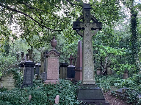 Several Victorian Celtic cross grave monuments in an overgrown cemetery