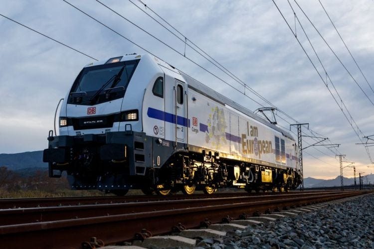 DB Cargo electric locomotive with "I am European" branding on railway track at sunset, freight transport in Europe