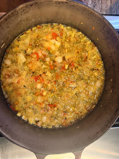Image 1: A white bowl filled with small shell pasta in a tomato-based broth with vegetables, served on a wooden table. A torn piece of rustic brown bread rests on the rim of the bowl. Image 2: A blue-and-yellow box of De Cecco Small Shells No. 52 pasta, showing the pasta through a clear window on the front. The packaging highlights that it is slow‑dried for superior quality and made in Italy. Image 3: A large pot filled with a simmering mixture of diced vegetables—such as onions, celery, and red peppers—in a seasoned broth, likely the base for a soup or pasta dish.