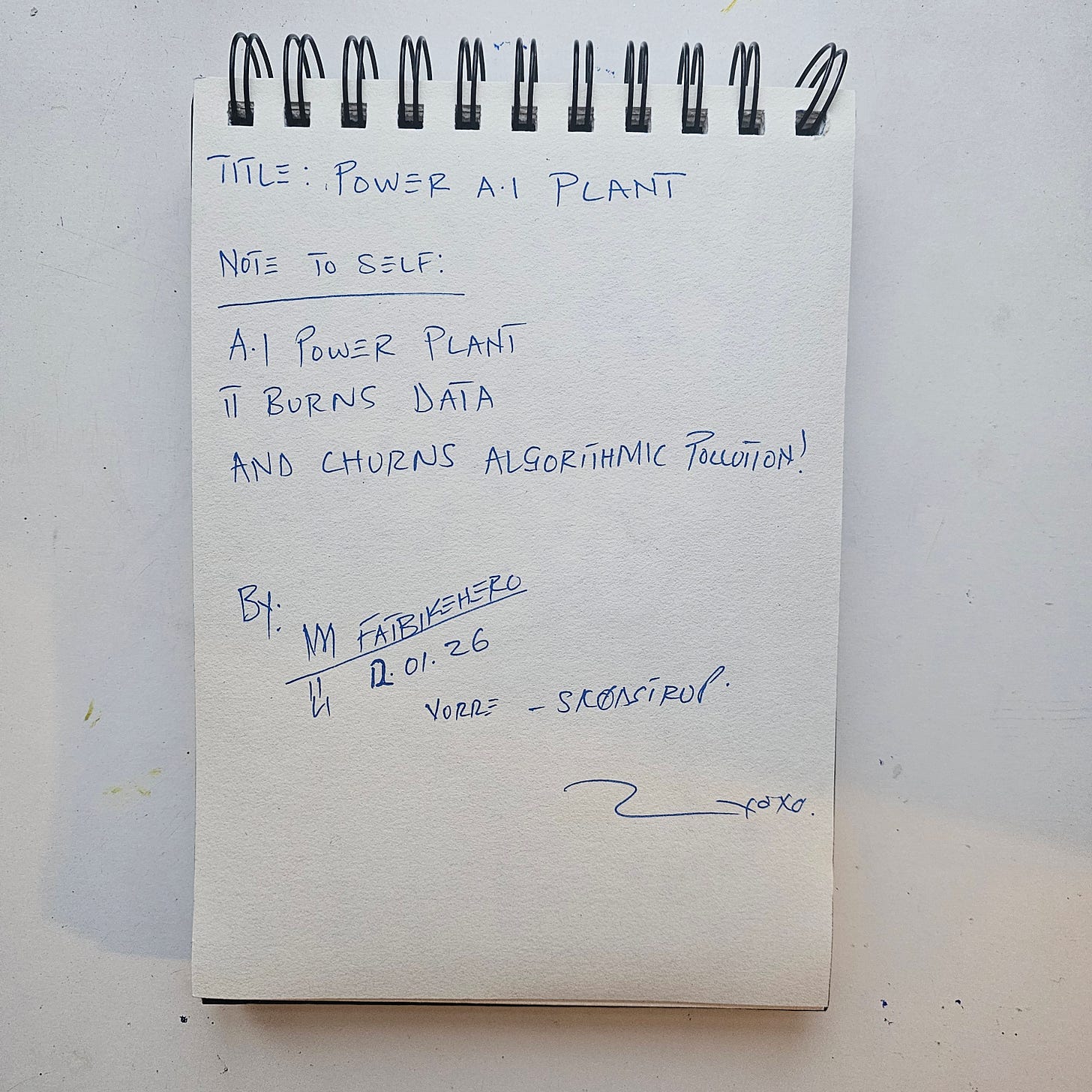 The handwritten reverse side of the artwork "Power A.I Plant" by FatbikeHero. Written in blue ink, the text reads: "TITLE: POWER A.I PLANT" followed by the artist's note: "A.I POWER PLANT / IT BURNS DATA / AND CHURNS ALGORITHMIC POLLUTION!" The page includes the artist's monogram signature, the date "12.01.26," and the location "VORRE-SKØDSTRUP."
