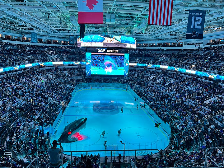 image of scoreboard, image of two smiling women, image of scoreboard, image of hockey rink