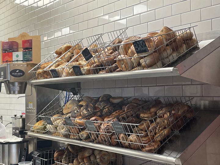 Bins of bagels on the left. Me pontificating on bagels on the right