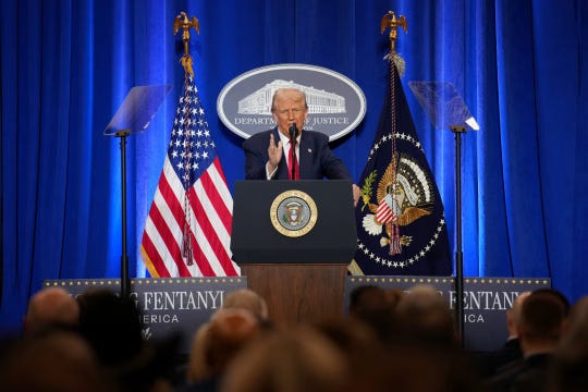 President Trump speaking at a lectern.