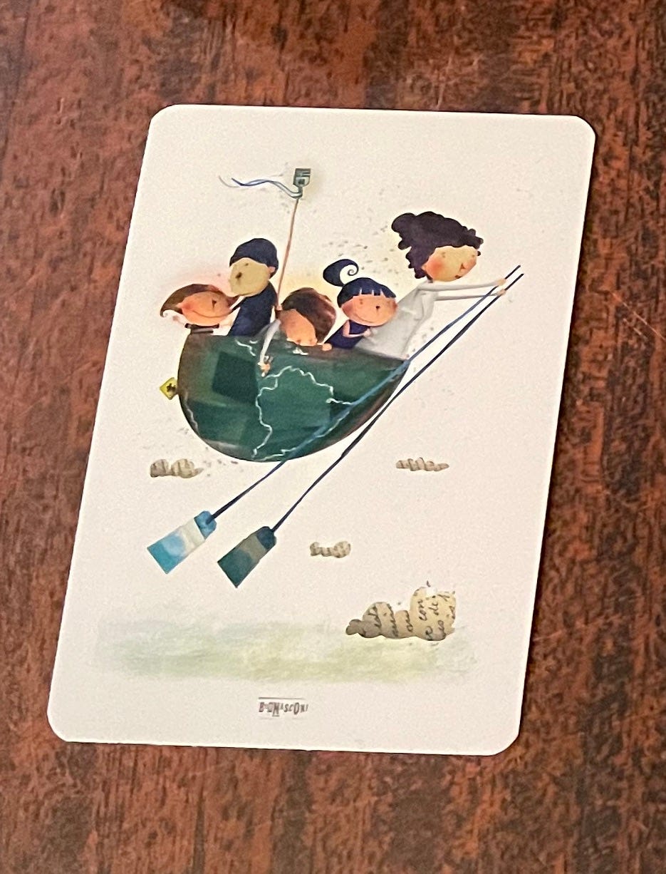 The card Jenny drew for her tarot reading on her career - shows a woman steering a boat full of children above clouds that have words in them