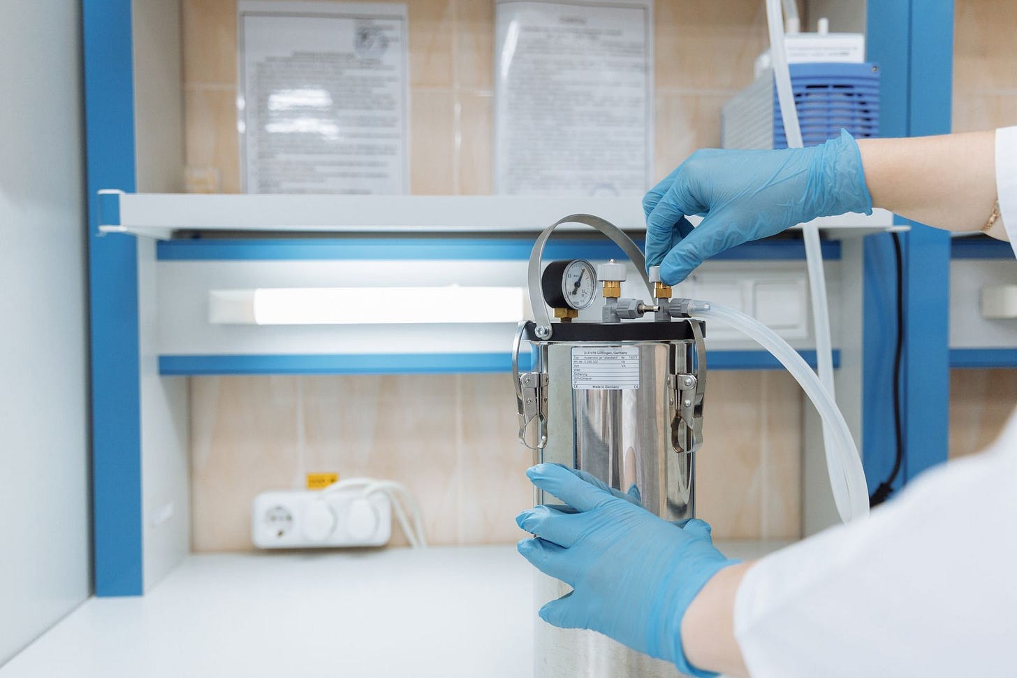 Photo by Thirdman on Pexels Scientist adjusting laboratory equipment with precision in a modern lab setting, wearing blue gloves. (stock photo)