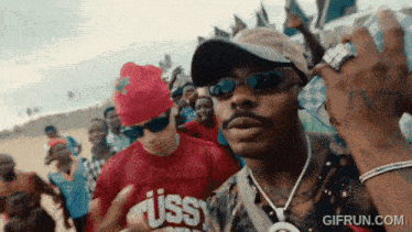 a man wearing sunglasses and a red shirt that says ' ass ' on it a man wearing sunglasses and a red shirt that says ' ass ' on it